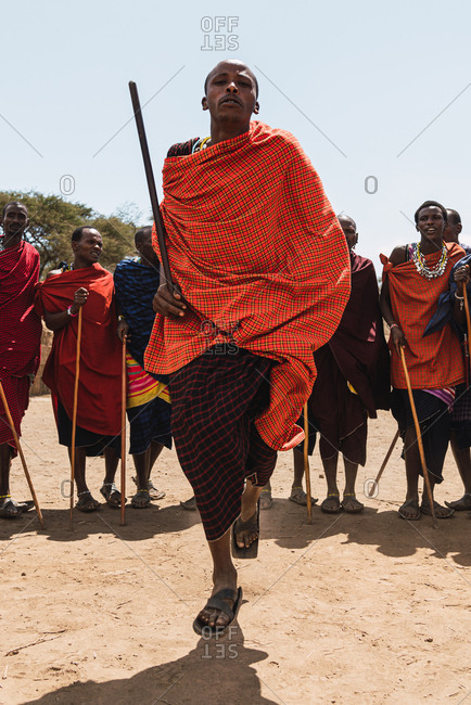 May 28, 2019: African Masai men jumping doing traditional dance in the middle of the savannah in Tanzania