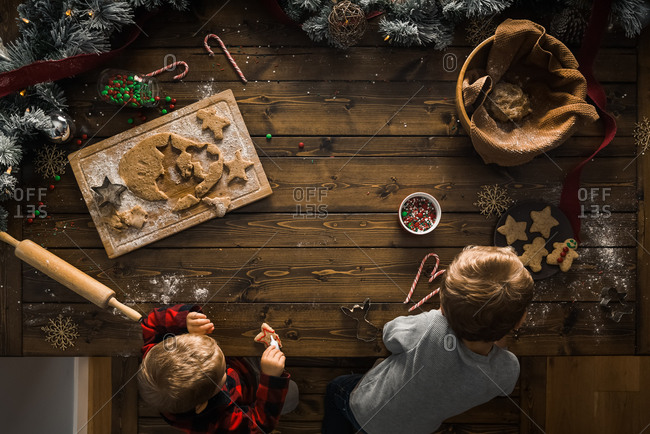 Overhead view of two young boys making Christmas cookies