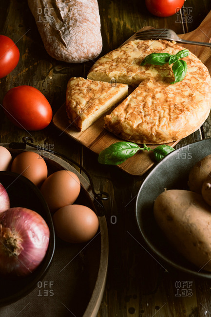 Cooking ingredients around pie on table