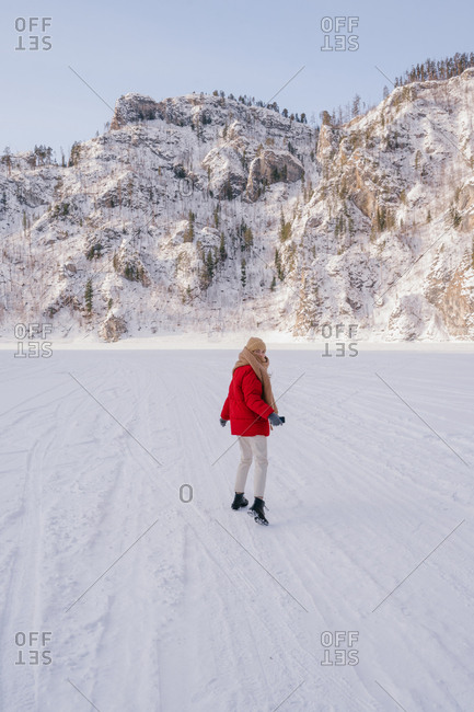 Frozen woman wrapped in scarf on winter day