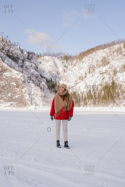 Frozen woman wrapped in scarf on winter day