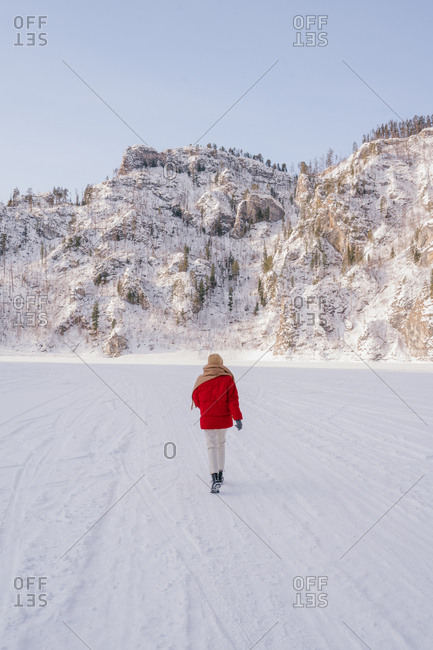 Frozen woman wrapped in scarf on winter day