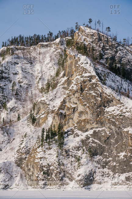 Winter landscape with snowy rocks and blue sky
