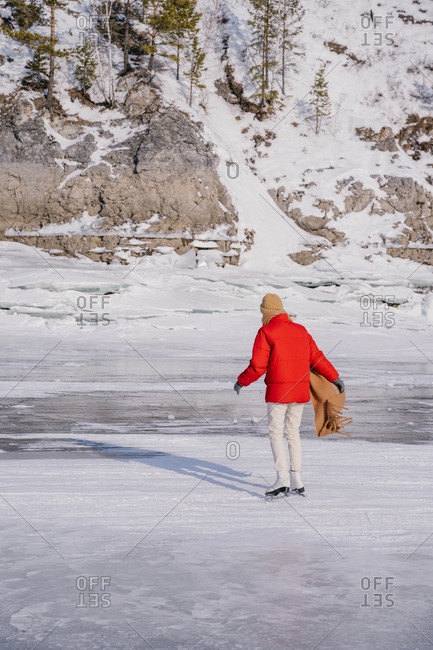 Woman skating on frozen river