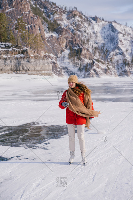 Woman skating on frozen river
