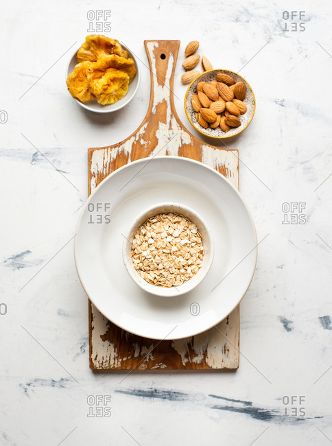 Oat bowl with dried pineapple and almond nuts from above