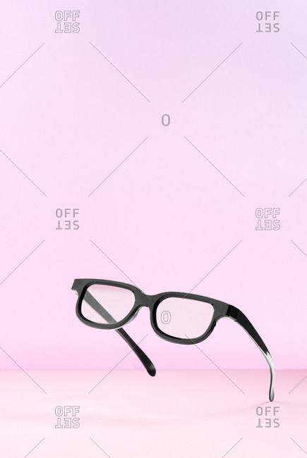 Pop art black frame sunglasses on pink background
