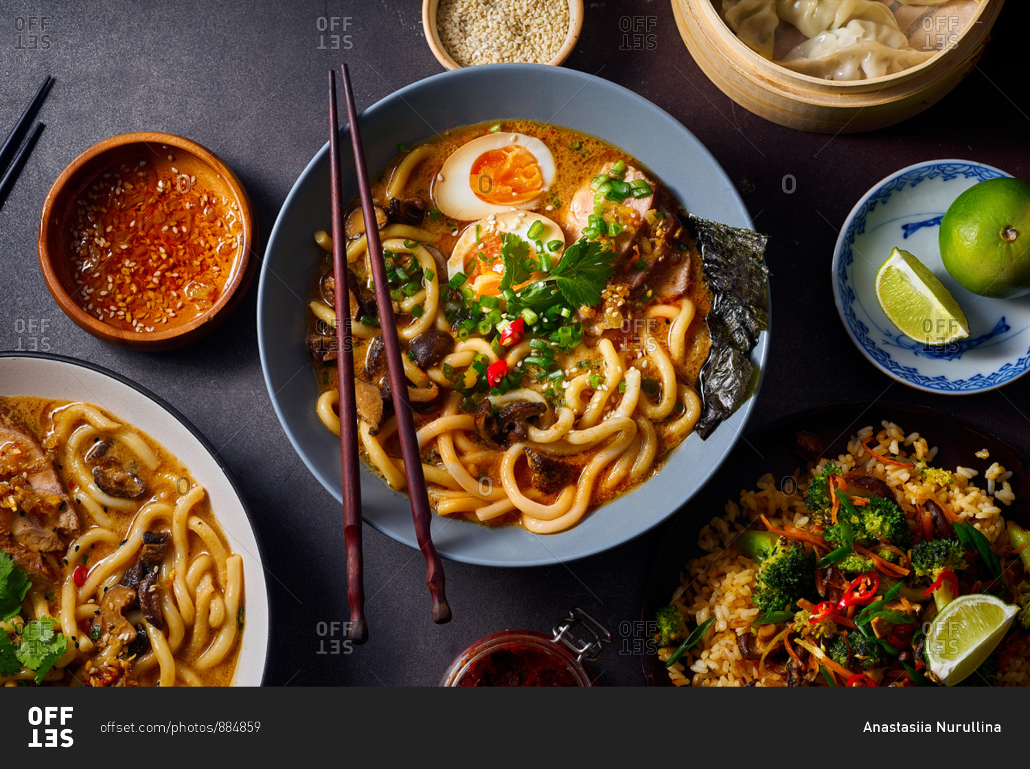 Asian cuisine dishes: pork ramen with soy-marinated eggs, vegetarian fried rice and gyoza dumplings served in a bamboo steamer