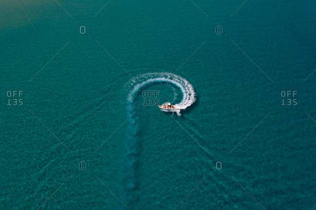 Aerial view of touristic speed boat sailing at Mediterranean sea, Italy.