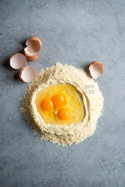 Semolina flour and eggs, ingredients for pasta dough from above with copyspace
