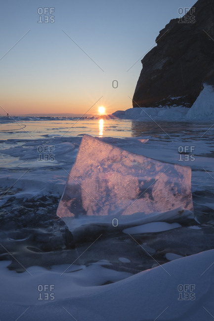 Crystal clear ice plate at sunset