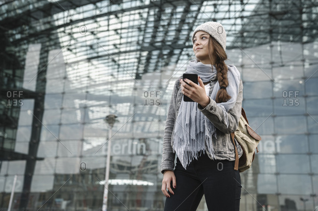 Young woman with smartphone waiting at the central station- Berlin- Germany