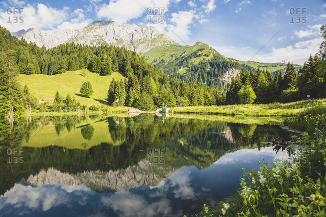Austria- Carinthia- Scenic view of shiny lake in Carnic Alps