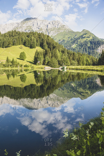Austria- Carinthia- Scenic view of shiny lake in Carnic Alps