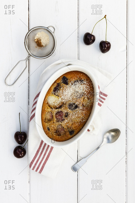 Bowl of gluten free homemade clafoutis with cherries- peaches and almonds
