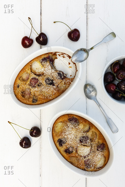 Bowls of gluten free homemade clafoutis with cherries- peaches and almonds