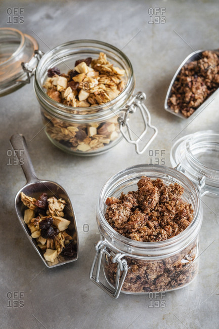 Jars and serving scoops of two homemade granola