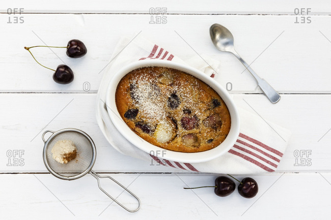 Bowl of gluten free homemade clafoutis with cherries- peaches and almonds