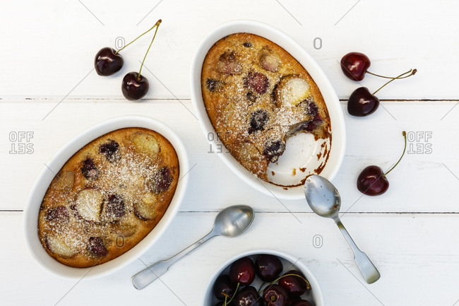 Bowls of gluten free homemade clafoutis with cherries- peaches and almonds