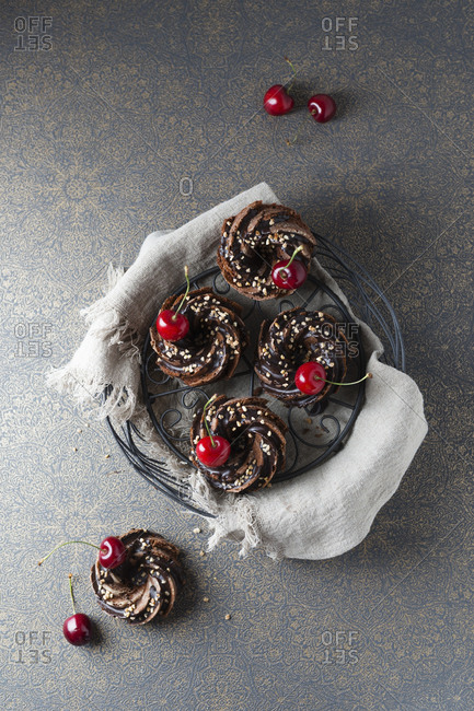Basket of German minigugelhupf cakes with chocolate- brittle and cherries