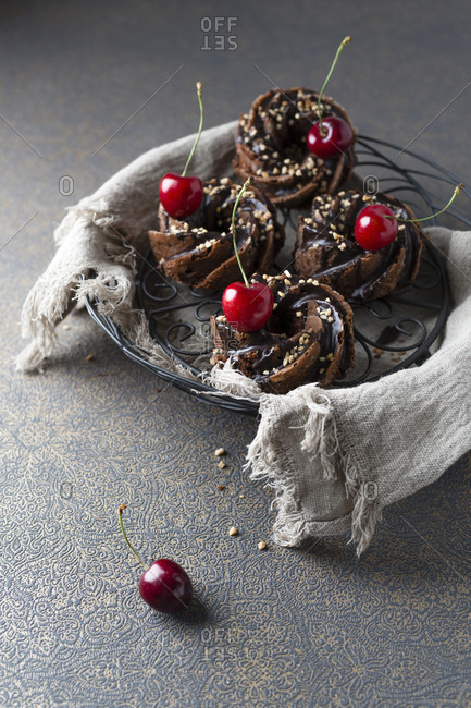 Basket of German minigugelhupf cakes with chocolate- brittle and cherries