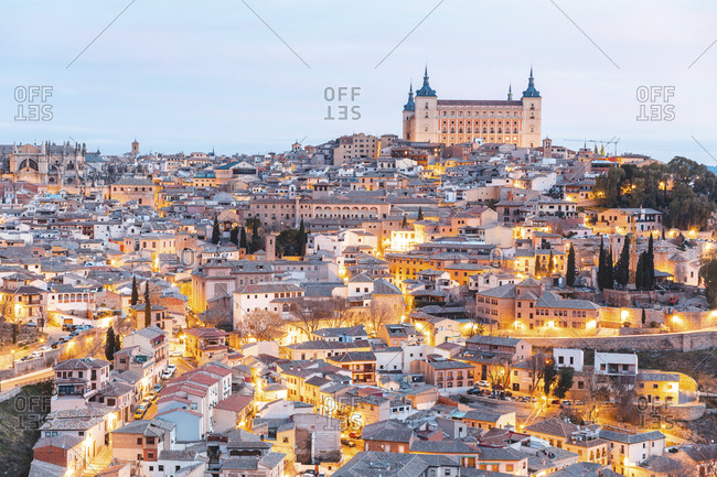 Spain- Province of Toledo- Toledo- Aerial view of illuminated city at dawn