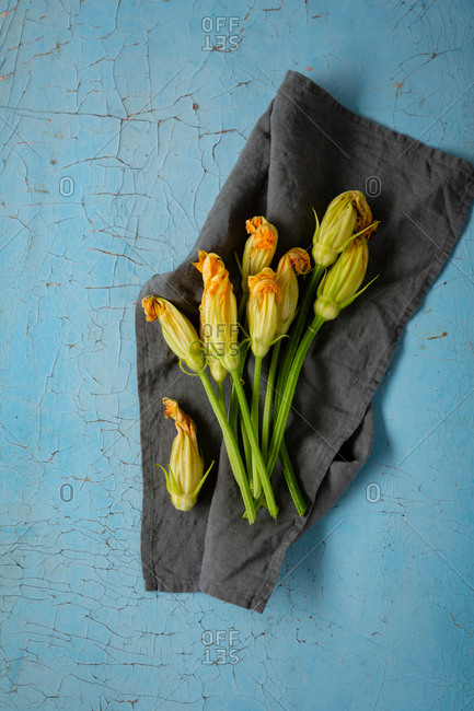 Zucchini flowers on a linen cloth