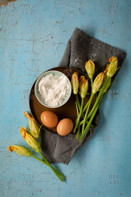 Zucchini flowers, eggs, and flowers on a tray