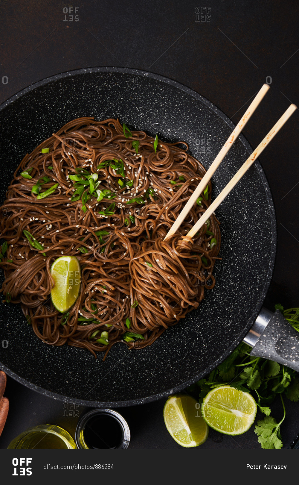 Top view of sesame noodles in a skillet with chopsticks