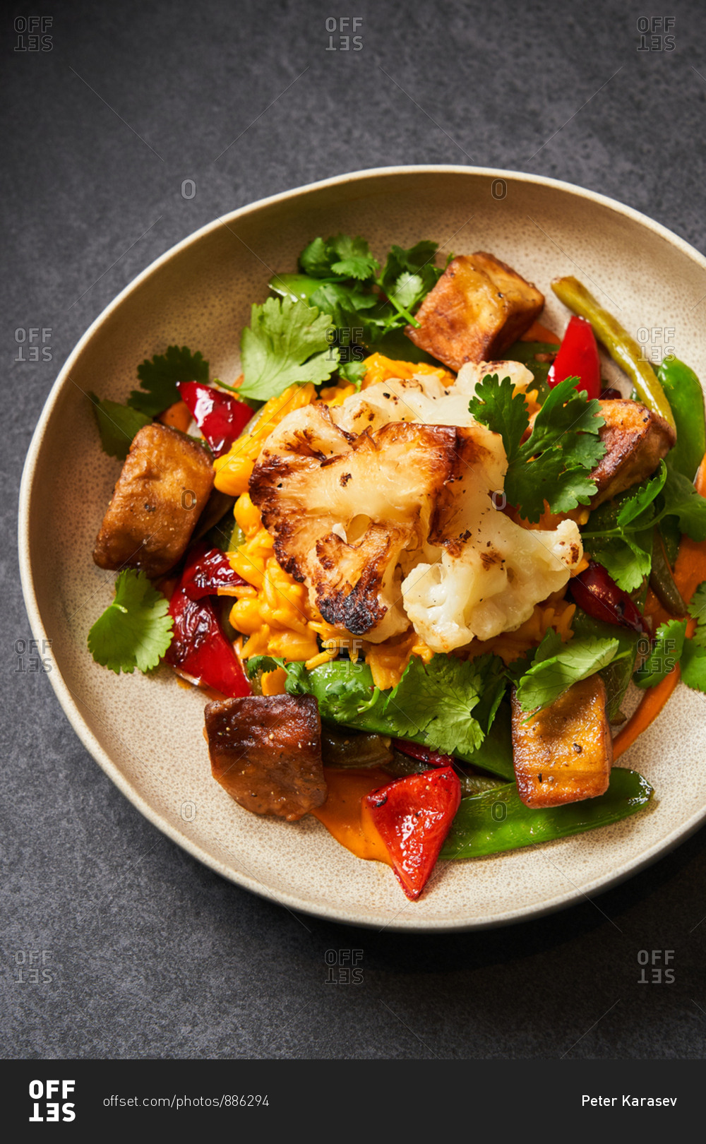 Colorful dish with grilled cauliflower and other veggies