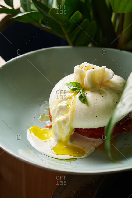 Gourmet poached egg dish with drizzled oil