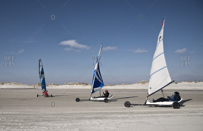 March 27, 2014: three beach sailor on the sandy beach sail with the wind