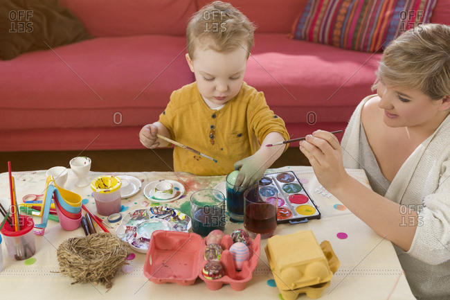 Mother, toddler, dyeing Easter eggs, smeared, colorful hands