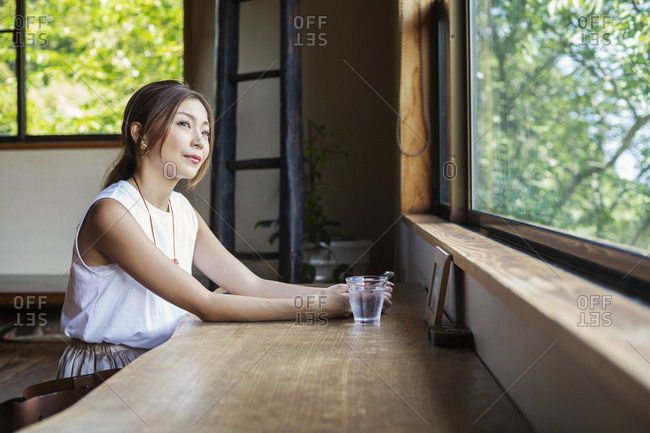 Japanese woman sitting at a table in a Japanese restaurant.