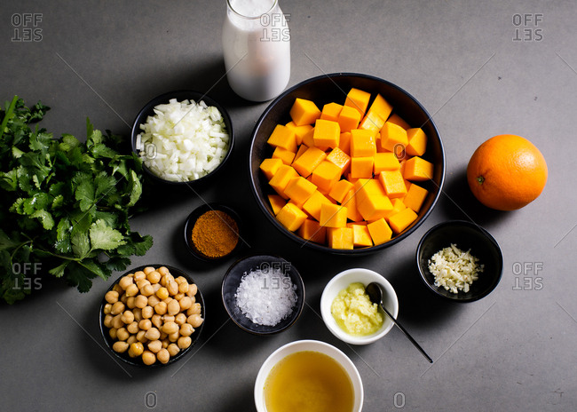 Butternut squash and other ingredients on gray surface
