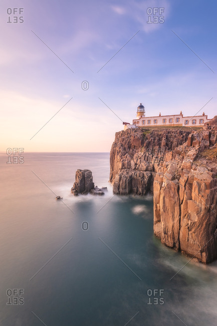 Neist Point Lighthouse by sea against sky during sunset at Waterstein- Isle of Skye- Highlands- Scotland- UK