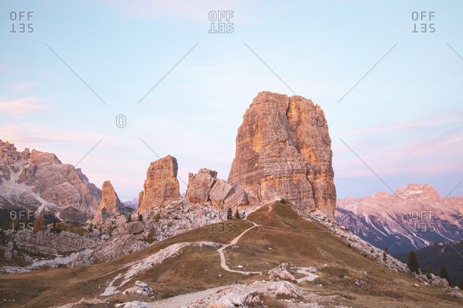 Scenic view of Cinque Torri and mountain range against sky during sunset- Italy