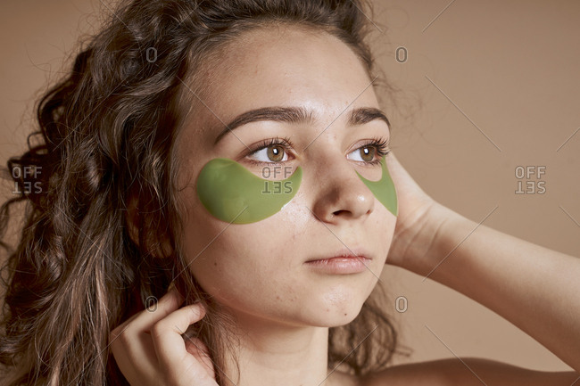Woman young and cute using beauty mask under eye