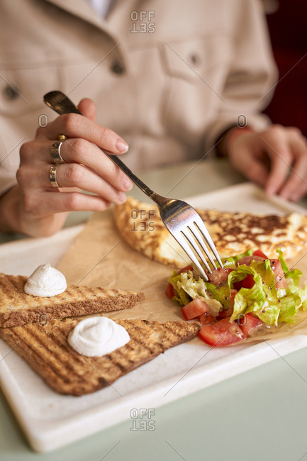 Woman eating healthy morning breakfast toast a vegetable salad