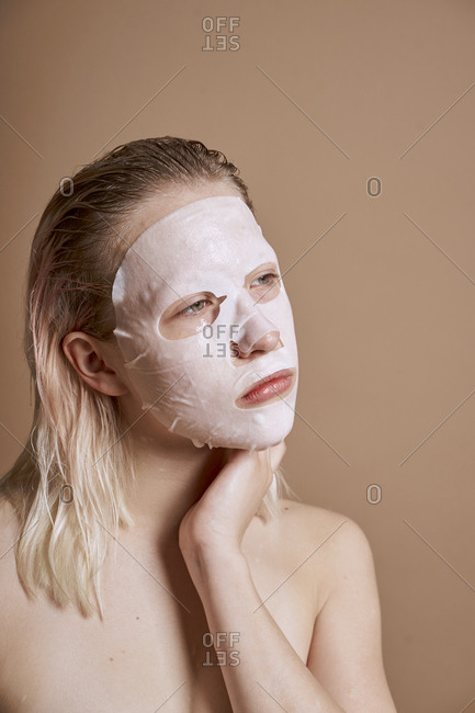 Woman young and cute using beauty face mask
