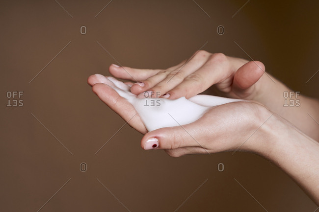 Female hands holding cleansing foam