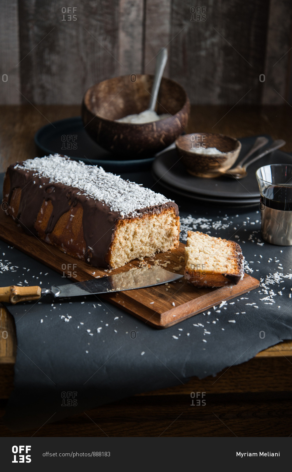 A coconut pound cake glazed with chocolate and coconut rasp ready to be shared