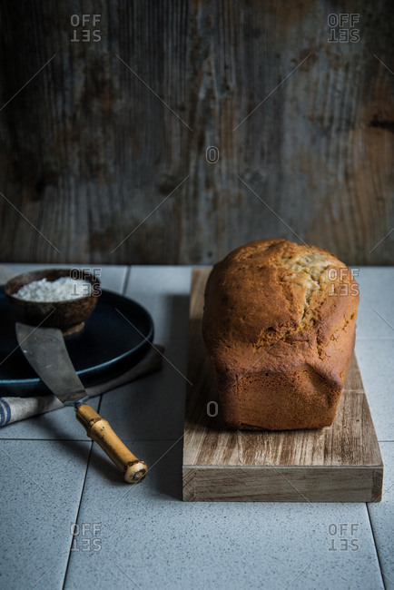 A just backed golden brown pound cake on a wooden board