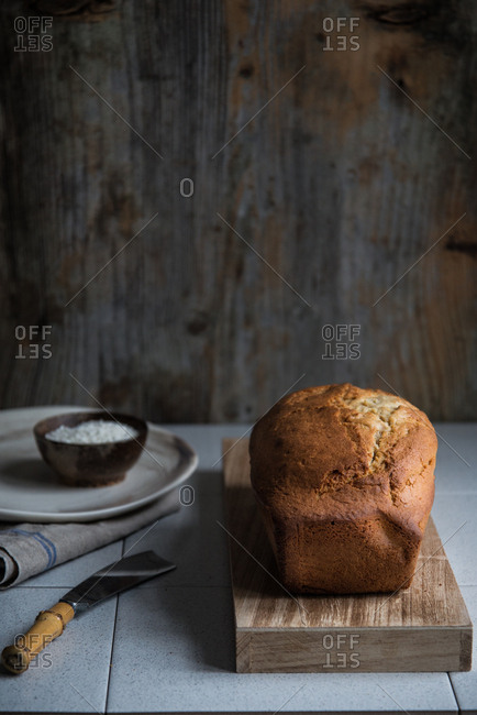 A just backed golden brown pound cake on a wooden board
