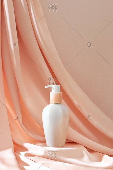 Bottle of luxury shower gel on pink.