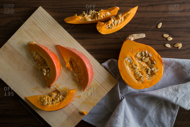 Winter squash cut on a wooden cutting board