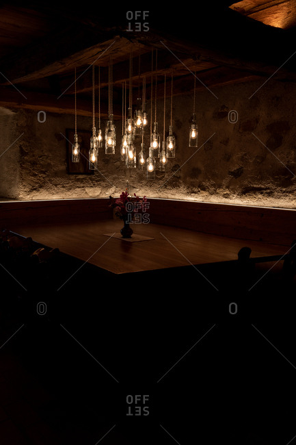 Meran, South Tyrol, Italy - October 1, 2019: Interior of a charming restaurant with several hanging lights above a corner table