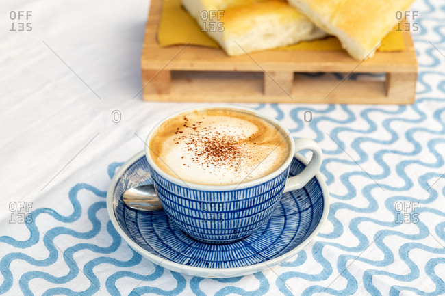 Close up of a cappuccino and focaccia