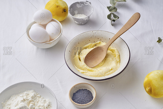 Mixing butter and sugar with wooden spoon while cooking lemon cake
