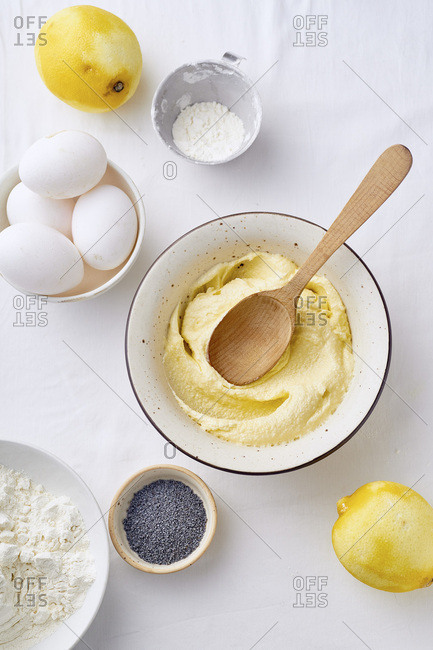 Mixing butter and sugar with wooden spoon while cooking lemon cake